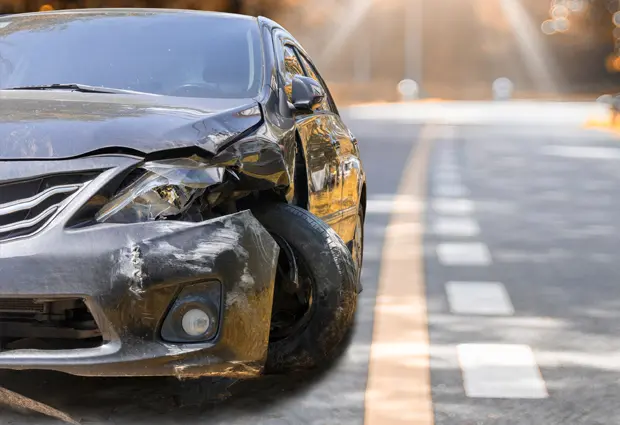 Car with a crumpled front fender, broken headlight, and damaged bumper